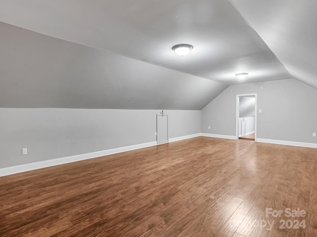 bonus room with lofted ceiling and hardwood / wood-style floors