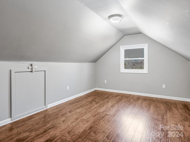 additional living space with lofted ceiling and hardwood / wood-style floors