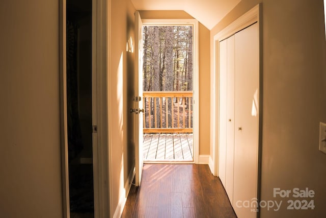 corridor featuring dark hardwood / wood-style flooring and lofted ceiling