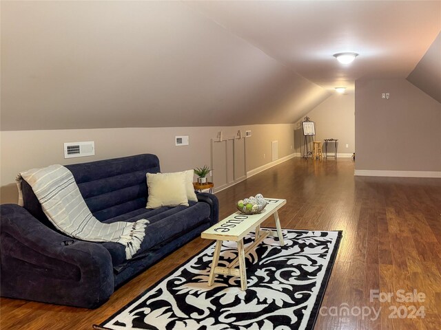 living room with lofted ceiling and dark hardwood / wood-style floors