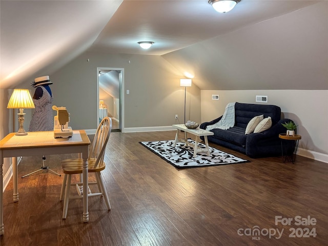 living room featuring lofted ceiling and dark hardwood / wood-style floors