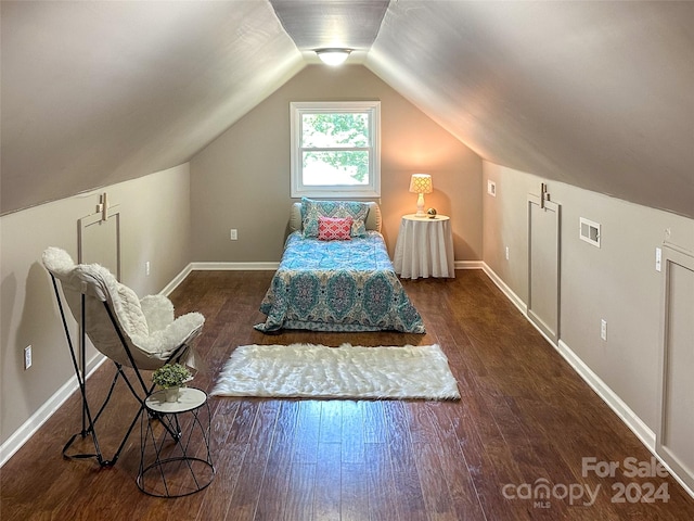 bedroom with vaulted ceiling and dark wood-type flooring