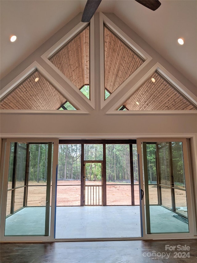 entryway with ceiling fan, a wealth of natural light, and high vaulted ceiling