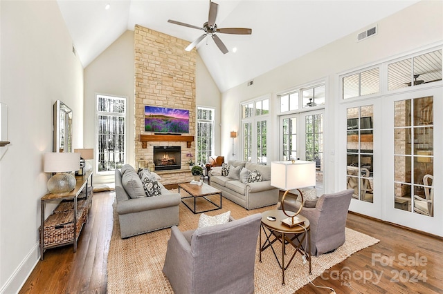 living room with high vaulted ceiling, hardwood / wood-style floors, a fireplace, and ceiling fan