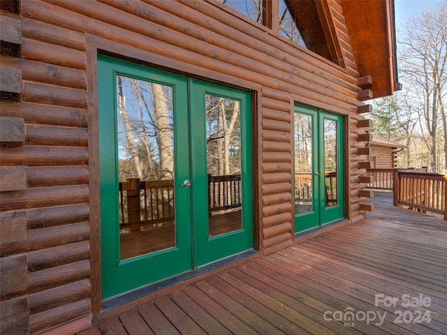 doorway to property with a wooden deck and french doors