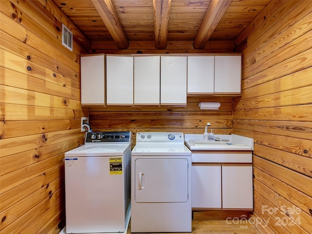 laundry area with cabinets, wood walls, and wood ceiling