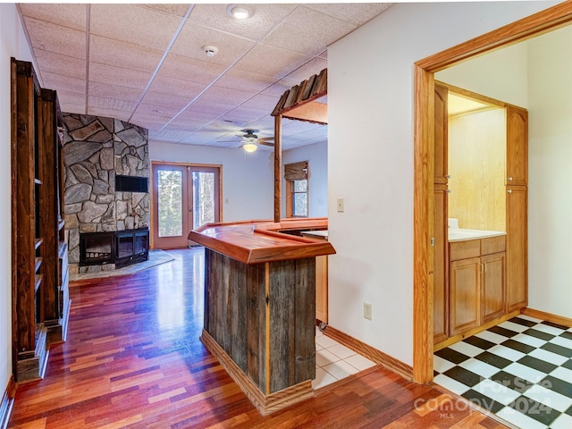 bar with french doors, a paneled ceiling, hardwood / wood-style flooring, and ceiling fan