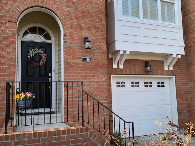 doorway to property with a garage