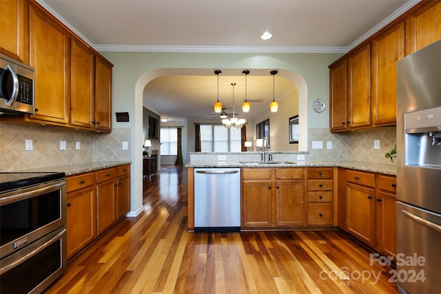 kitchen with appliances with stainless steel finishes, backsplash, and dark wood-type flooring