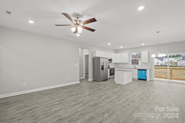 kitchen featuring stainless steel appliances, white cabinetry, and light hardwood / wood-style floors