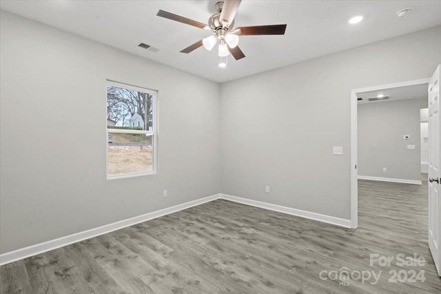 spare room with ceiling fan and dark hardwood / wood-style flooring