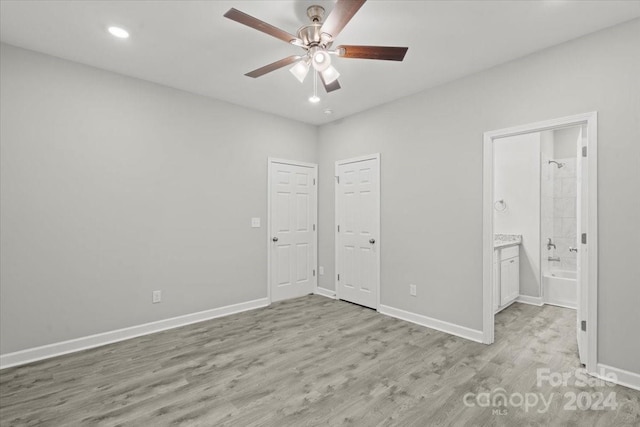 unfurnished bedroom featuring ceiling fan, light hardwood / wood-style flooring, and ensuite bathroom