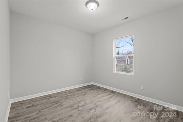 empty room with dark wood-type flooring