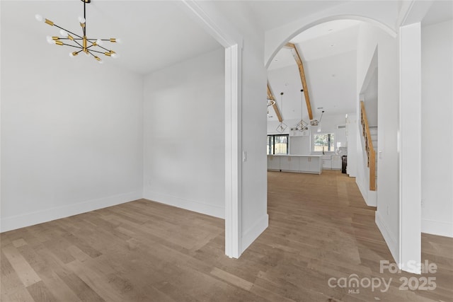 entrance foyer featuring an inviting chandelier and light hardwood / wood-style flooring