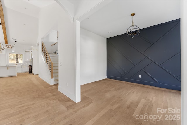 unfurnished dining area with light hardwood / wood-style floors and a chandelier