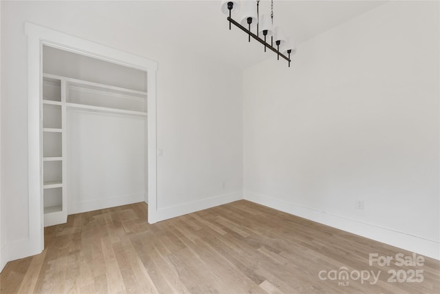 unfurnished bedroom featuring a closet and light hardwood / wood-style flooring