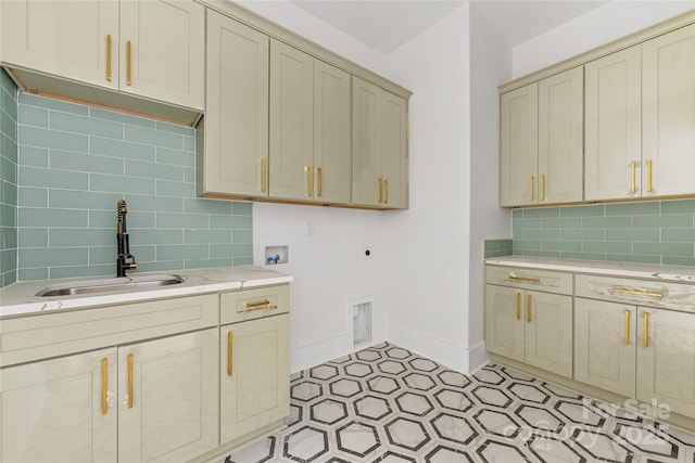 kitchen featuring sink, backsplash, and cream cabinetry