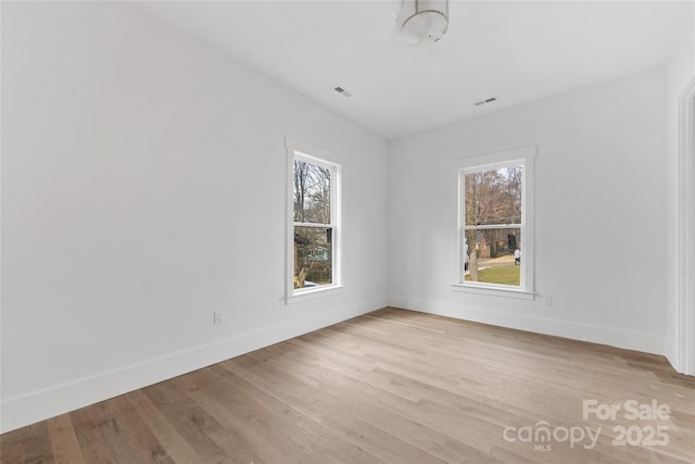 empty room with light hardwood / wood-style floors