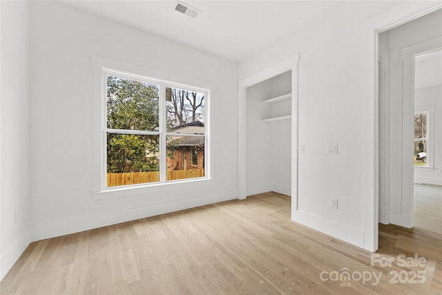 unfurnished bedroom featuring a closet and light hardwood / wood-style flooring