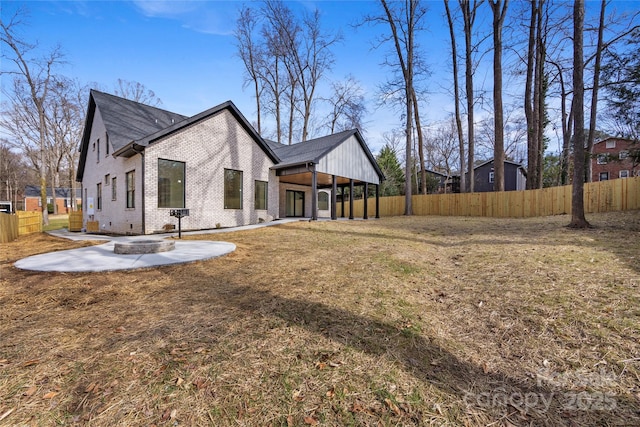 view of side of home with a yard and a patio area