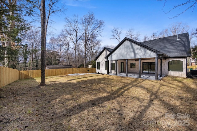 back of property featuring a patio area and a lawn