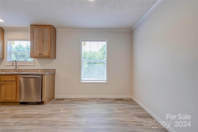 kitchen with a textured ceiling, a wealth of natural light, dishwasher, and sink