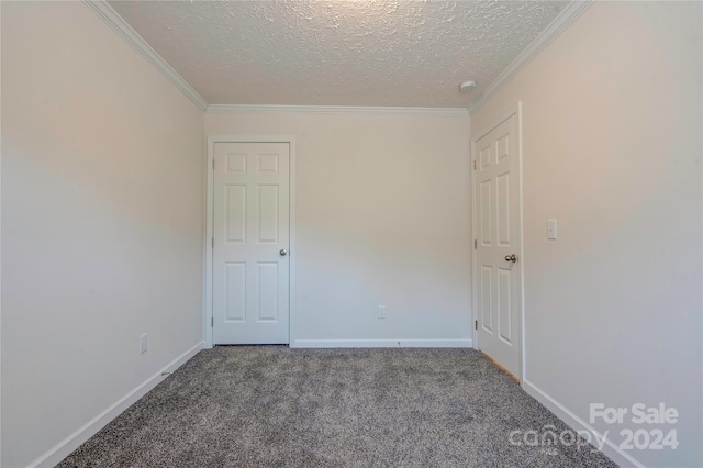 unfurnished room featuring carpet, a textured ceiling, and ornamental molding