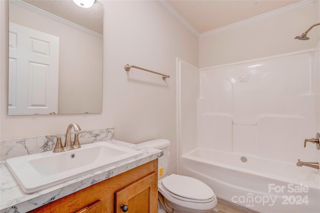 full bathroom featuring toilet, vanity, crown molding, a textured ceiling, and bathtub / shower combination