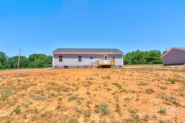 rear view of property with a wooden deck