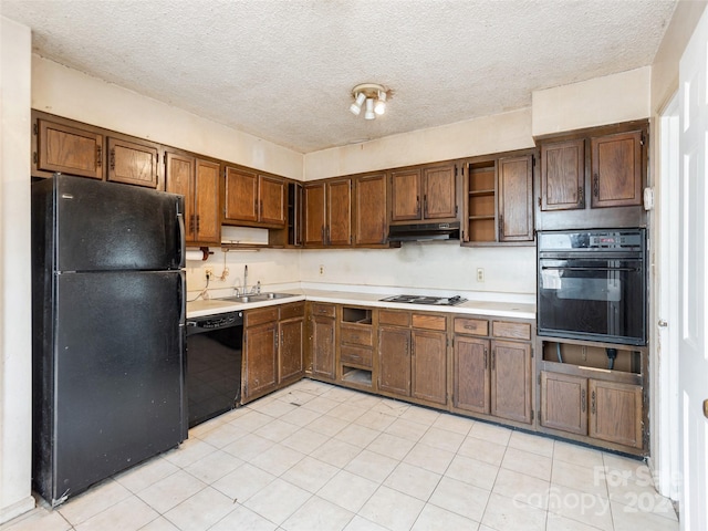 kitchen featuring light tile flooring, a textured ceiling, black appliances, and sink