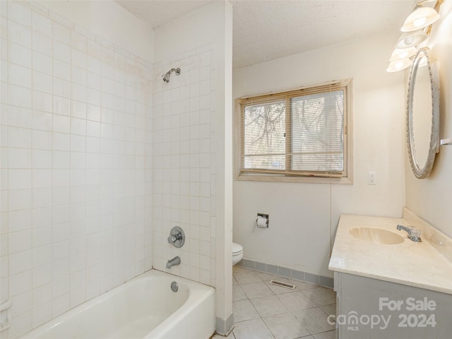 full bathroom with toilet, a textured ceiling, vanity, tiled shower / bath, and tile flooring