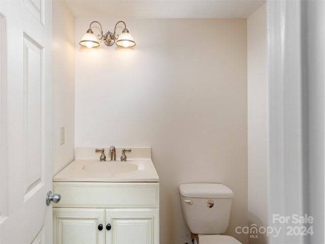 bathroom featuring toilet and vanity