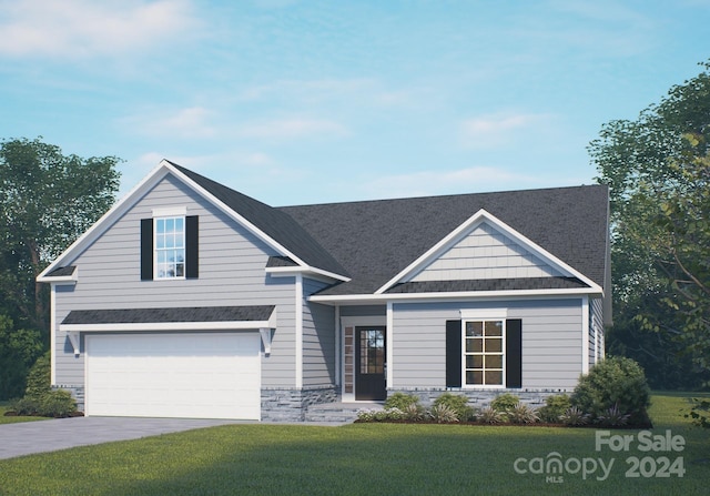 view of front of home with a front lawn and a garage