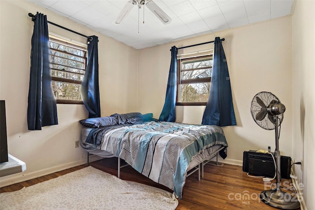 bedroom with dark wood-type flooring and ceiling fan