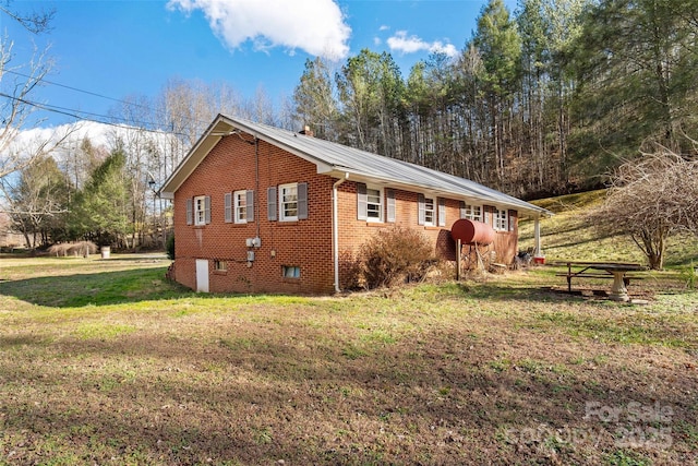 view of side of property with a yard