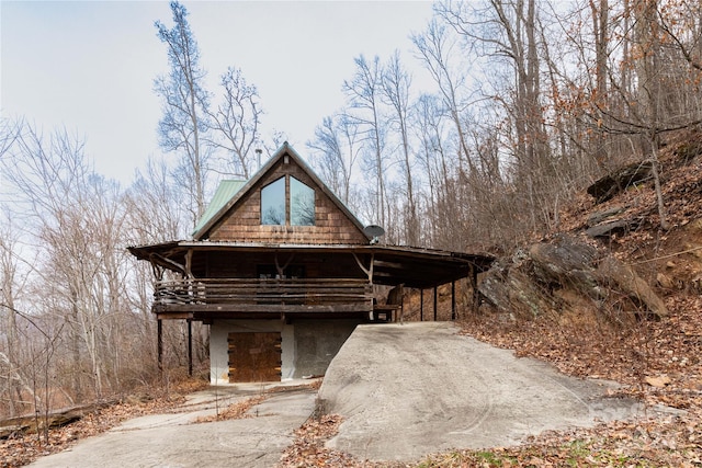 log home featuring a carport