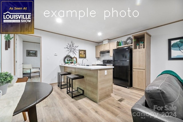 kitchen featuring light brown cabinetry, ornamental molding, light hardwood / wood-style floors, range, and black refrigerator