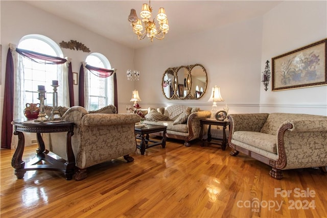 living room with light hardwood / wood-style floors and a chandelier