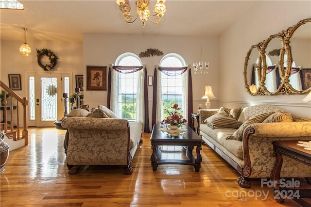 living room featuring a notable chandelier and wood-type flooring