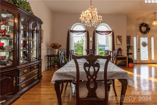 dining area with an inviting chandelier and light wood-type flooring