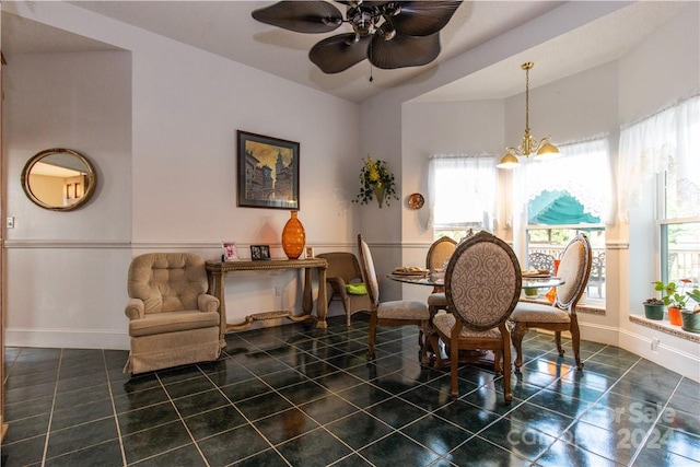 interior space with ceiling fan with notable chandelier