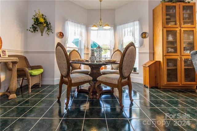 tiled dining space featuring a chandelier