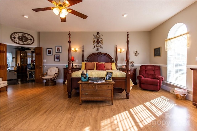 bedroom with light hardwood / wood-style flooring and ceiling fan