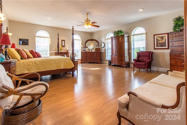 bedroom featuring multiple windows, ceiling fan, and light hardwood / wood-style flooring