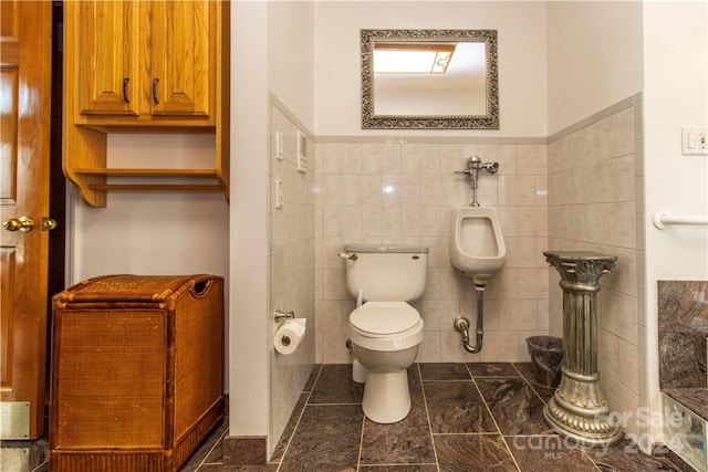 bathroom featuring tile walls, toilet, and tile floors