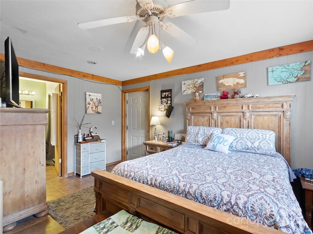 tiled bedroom featuring ceiling fan