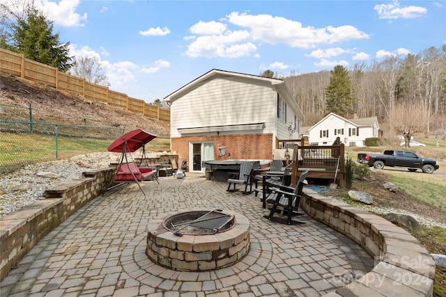 view of terrace featuring an outdoor fire pit and a deck