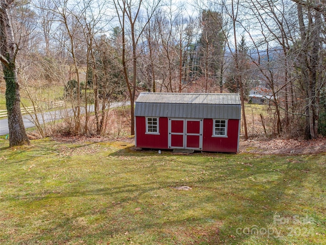 view of shed / structure with a lawn