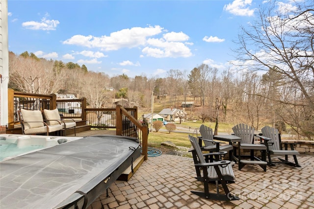 view of patio with a deck and a hot tub