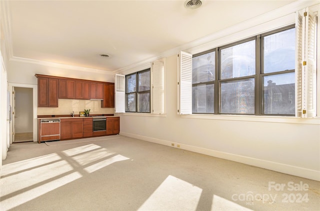 kitchen featuring appliances with stainless steel finishes, ornamental molding, light colored carpet, and tasteful backsplash